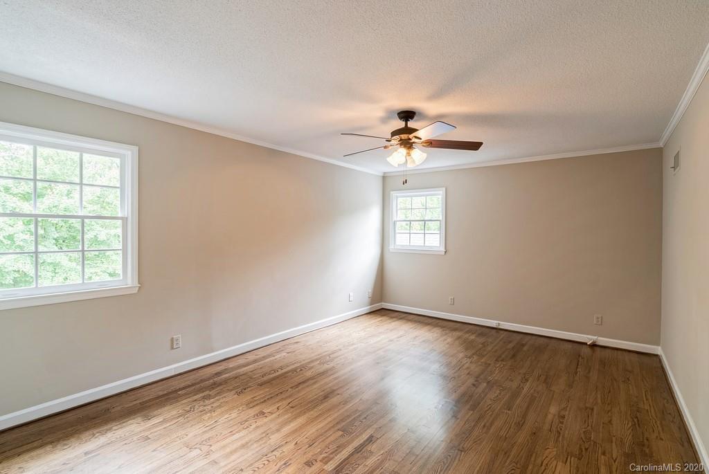 4200 Chelmsford Road Charlotte, NC 28211 - Photo 38 of 45 a view of an empty room with a window and wooden floor