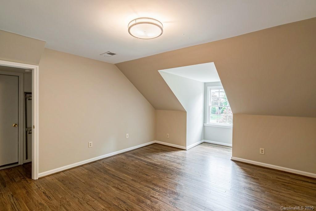 4200 Chelmsford Road Charlotte, NC 28211 - Photo 39 of 45 a view of an empty room with wooden floor and a window