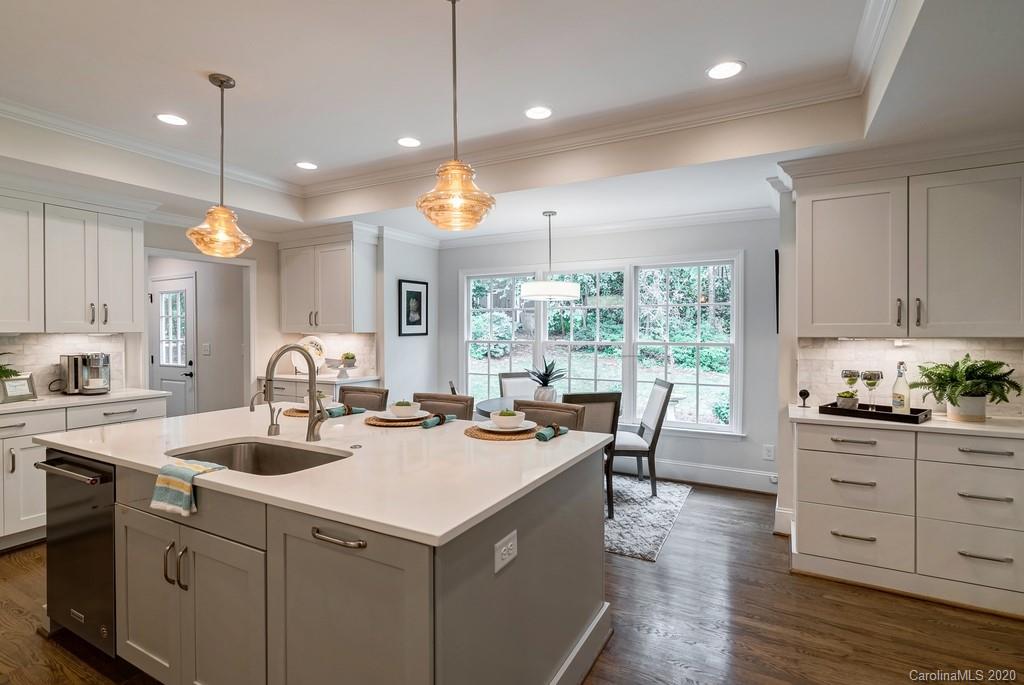 4200 Chelmsford Road Charlotte, NC 28211 - Photo 7 of 45 a kitchen that has a lot of cabinets a sink and wooden floor