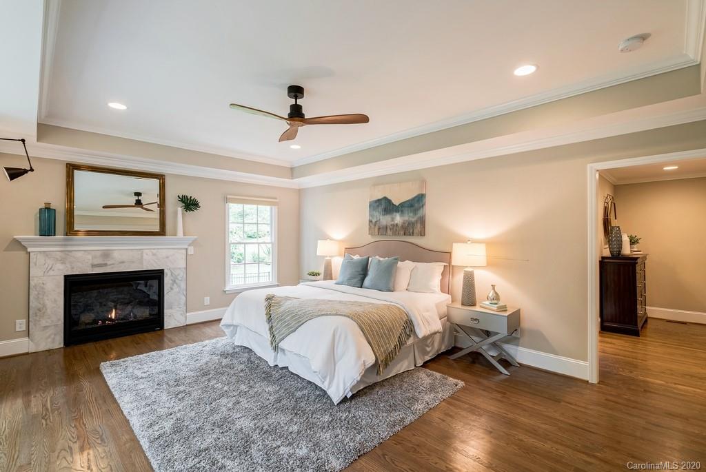 4200 Chelmsford Road Charlotte, NC 28211 - Photo 10 of 45 a spacious bedroom with a large bed and a fireplace
