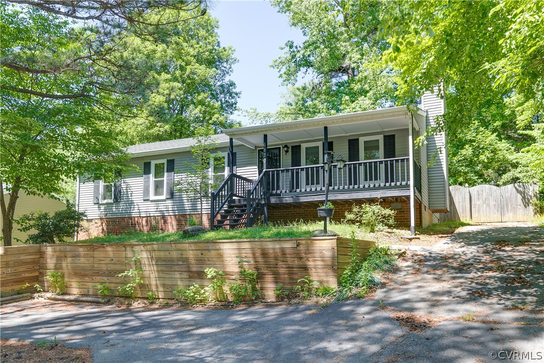 a front view of a house with a yard near a lake