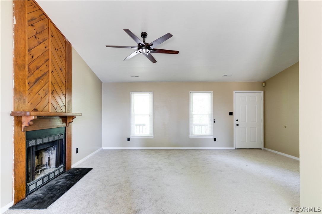 6430 Jessup Road Chesterfield, VA 23832 - Photo 8 of 26 a view of a livingroom with a fireplace a ceiling fan and windows