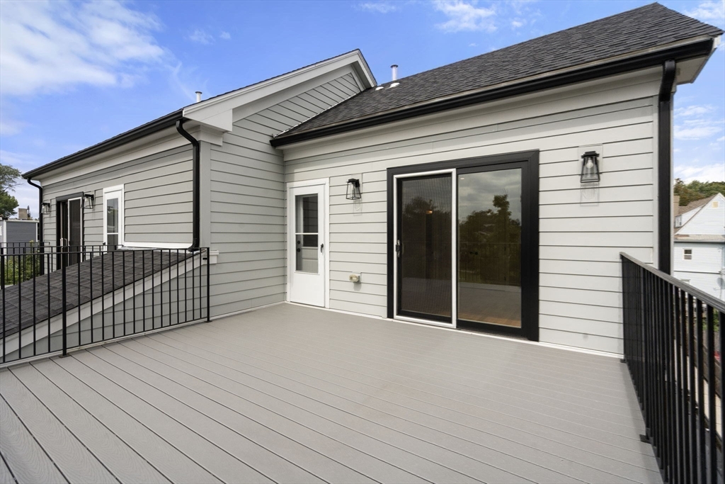 123-125 Centre Street, Unit TH7 Boston, MA 02124 - Photo 13 of 37 a view of a house with a wooden deck