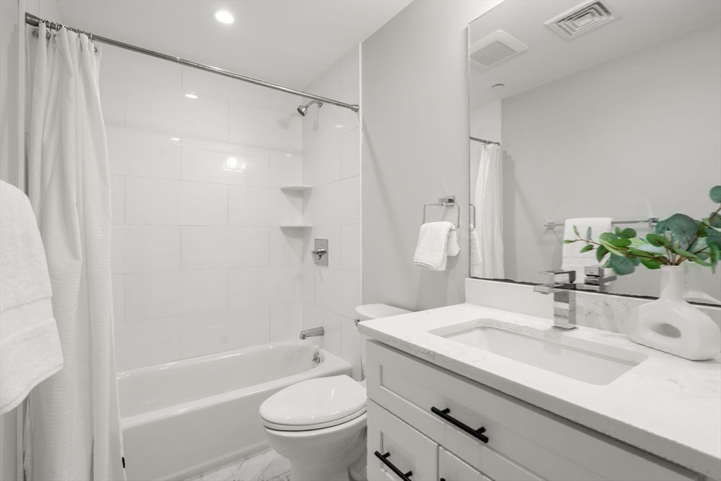 123-125 Centre Street, Unit TH7 Boston, MA 02124 - Photo 22 of 37 a bathroom with a sink toilet and shower