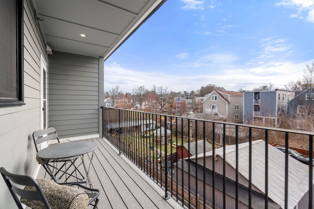 123-125 Centre Street, Unit TH7 Boston, MA 02124 - Photo 26 of 37 a view of a balcony with wooden floor