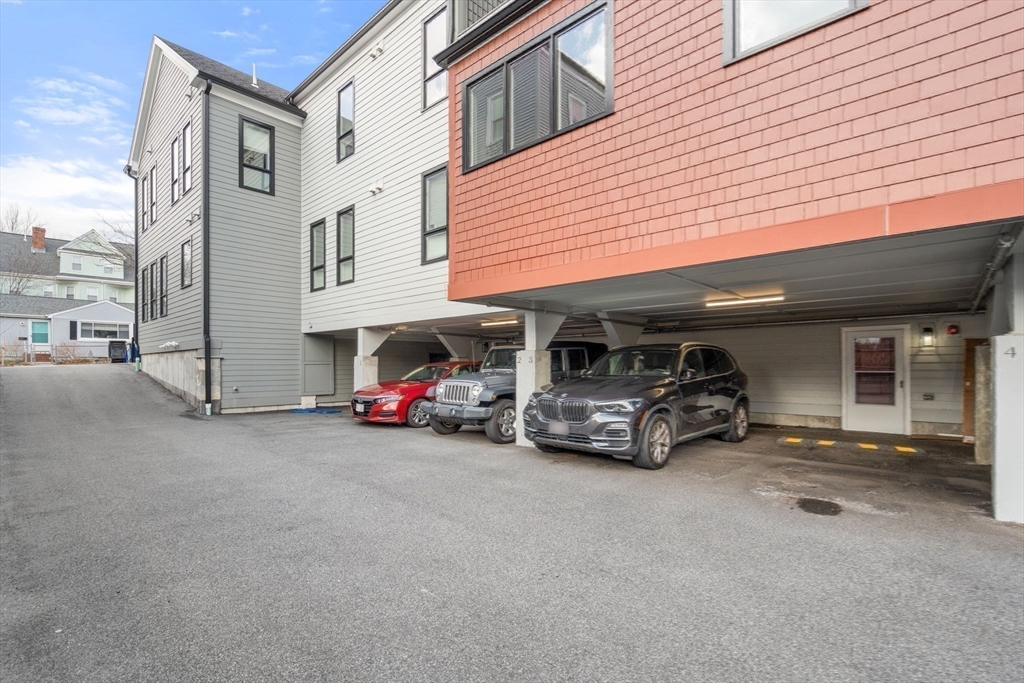 123-125 Centre Street, Unit TH7 Boston, MA 02124 - Photo 27 of 37 a view of a cars park in front of a house