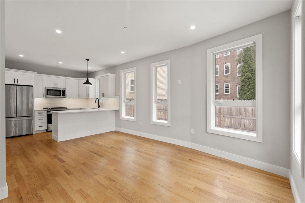 123-125 Centre Street, Unit TH7 Boston, MA 02124 - Photo 6 of 37 a view of kitchen with stainless steel appliances refrigerator oven and cabinets