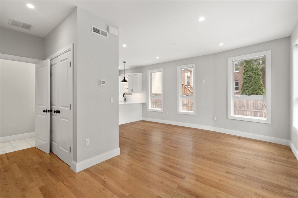 123-125 Centre Street, Unit TH7 Boston, MA 02124 - Photo 8 of 37 a view of an empty room with wooden floor and a window