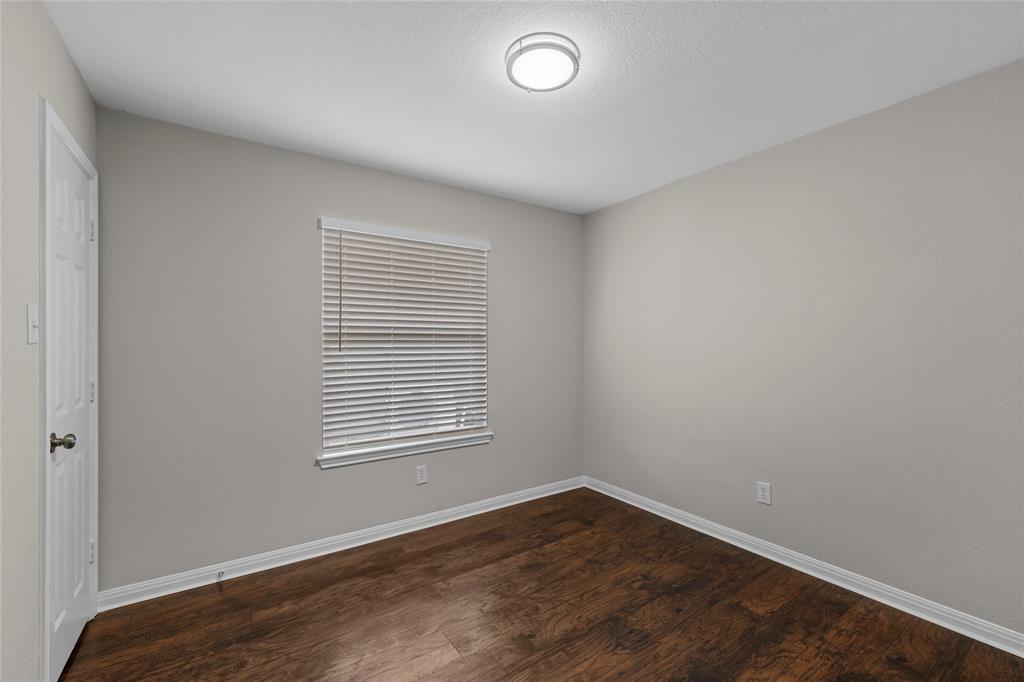 10124 Bunting Drive Waco, TX 76708 - Photo 11 of 18 an empty room with wooden floor and windows