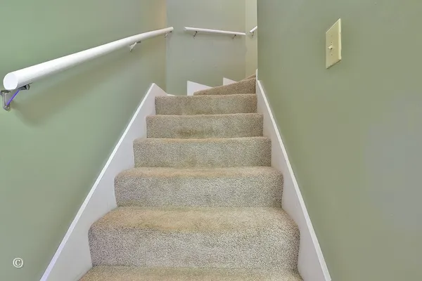 a view of staircase with white walls