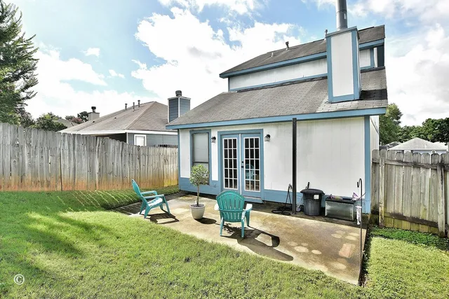 a view of a house with backyard sitting area and garden