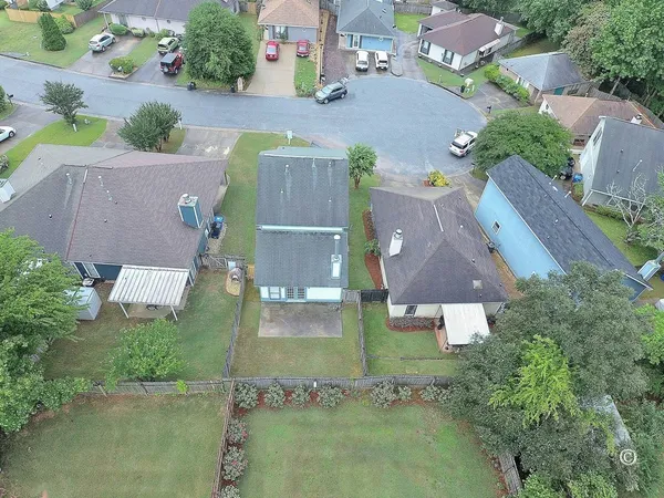an aerial view of residential houses with outdoor space and swimming pool