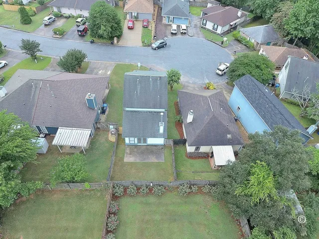an aerial view of residential houses with outdoor space and swimming pool