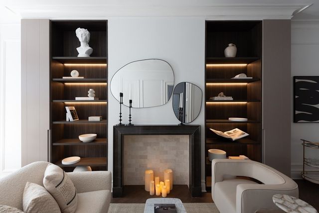 a living room with furniture a lamp and window