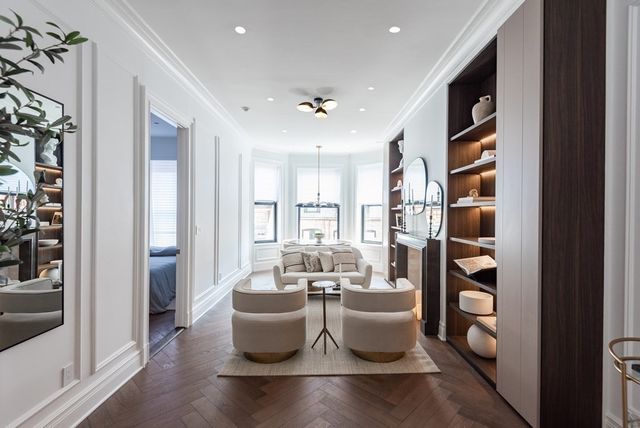 a large room with a large window and furniture