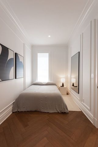 a bedroom with a bed and a night stand