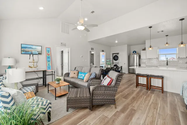 a living room with lots of furniture and kitchen view