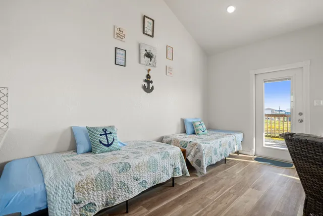 a bedroom with two beds and painting on the wall