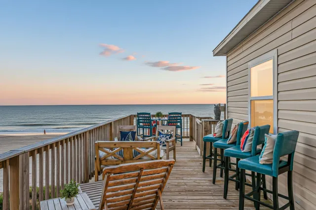 a terrace of a house with wooden floor outdoor seating and city view