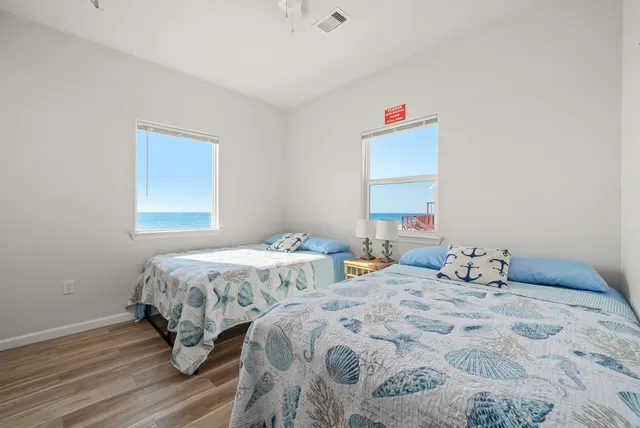 a bedroom with two beds and a closet