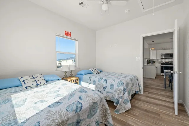 a bedroom with two beds and a window