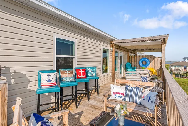 a outdoor living space with furniture and a flat screen tv