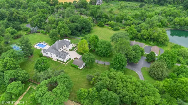 an aerial view of a house with a yard basket ball court and outdoor seating