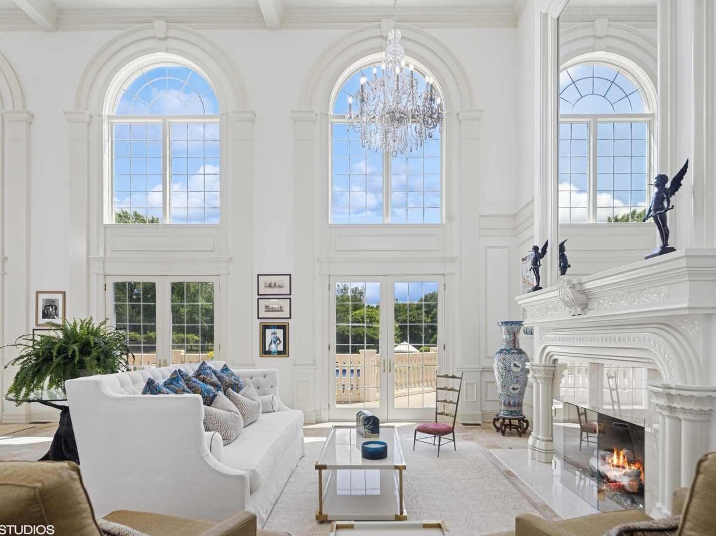 5-n113 Burr Road St. Charles, IL 60175 - Photo 12 of 130 a living room with furniture a fireplace and a chandelier