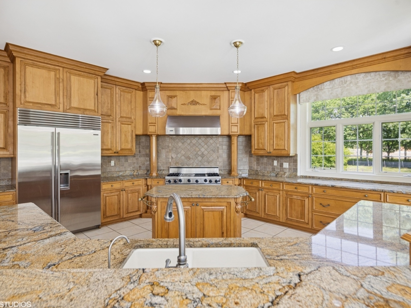 5-n113 Burr Road St. Charles, IL 60175 - Photo 24 of 130 a kitchen with stainless steel appliances granite countertop a stove a refrigerator and a sink