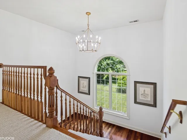 a living room with furniture a fireplace and large windows