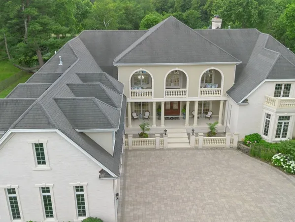 a dining room with furniture a chandelier and window