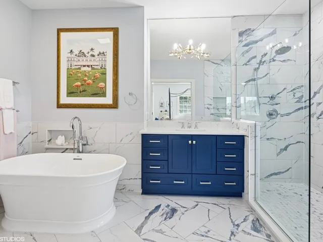 an aerial view of residential house with outdoor space and trees all around