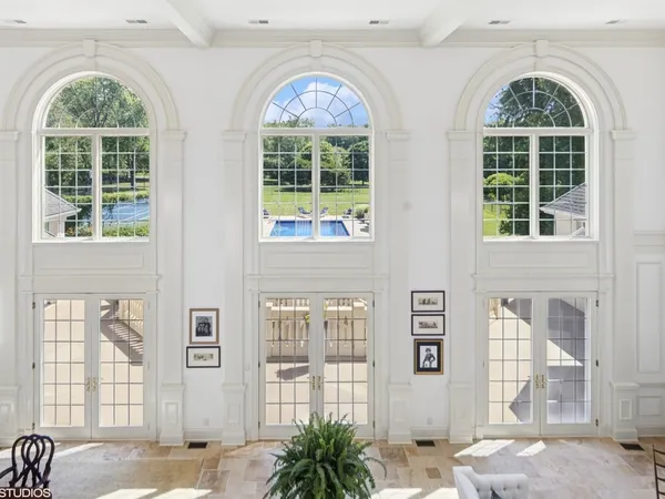 a bathroom with a granite countertop sink a large mirror and a window