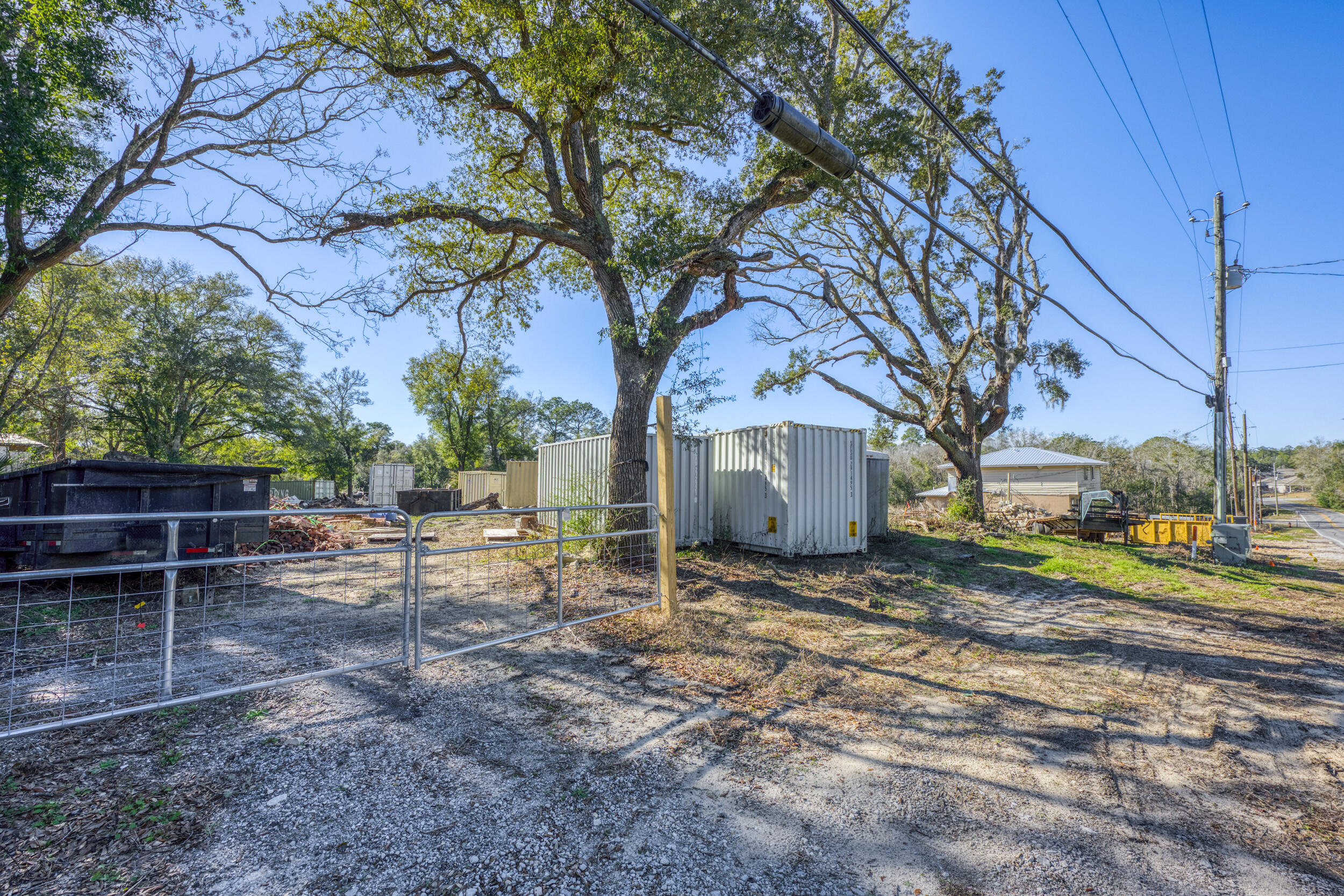 309 Kelly Road Niceville, FL 32578 - Photo 5 of 8 a view of a backyard with wooden fence and large trees