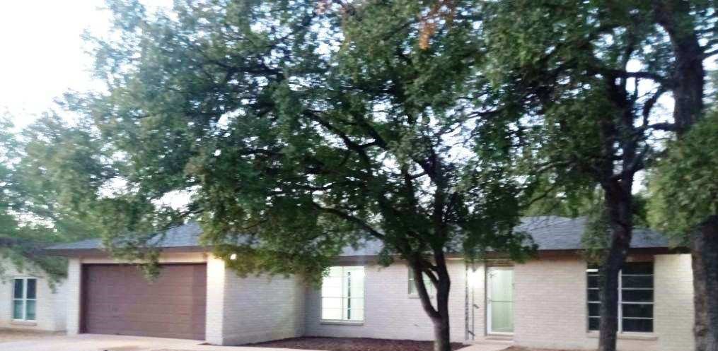 a view of house with tree in front of it