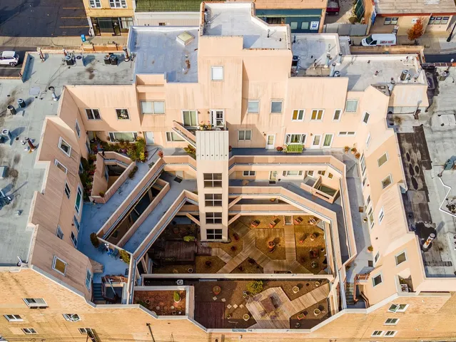 an aerial view of a building with parking