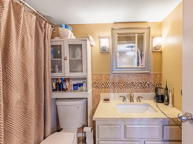a bathroom with a sink toilet and shower