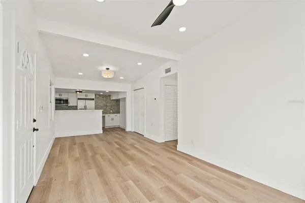 a large white kitchen with kitchen island a sink a stove and a refrigerator
