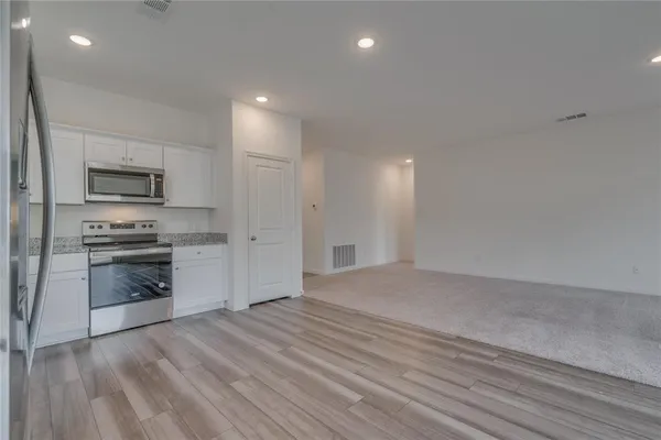 a view of kitchen with microwave and stove
