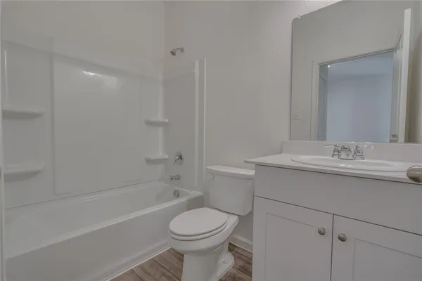 a bathroom with a sink toilet vanity and shower