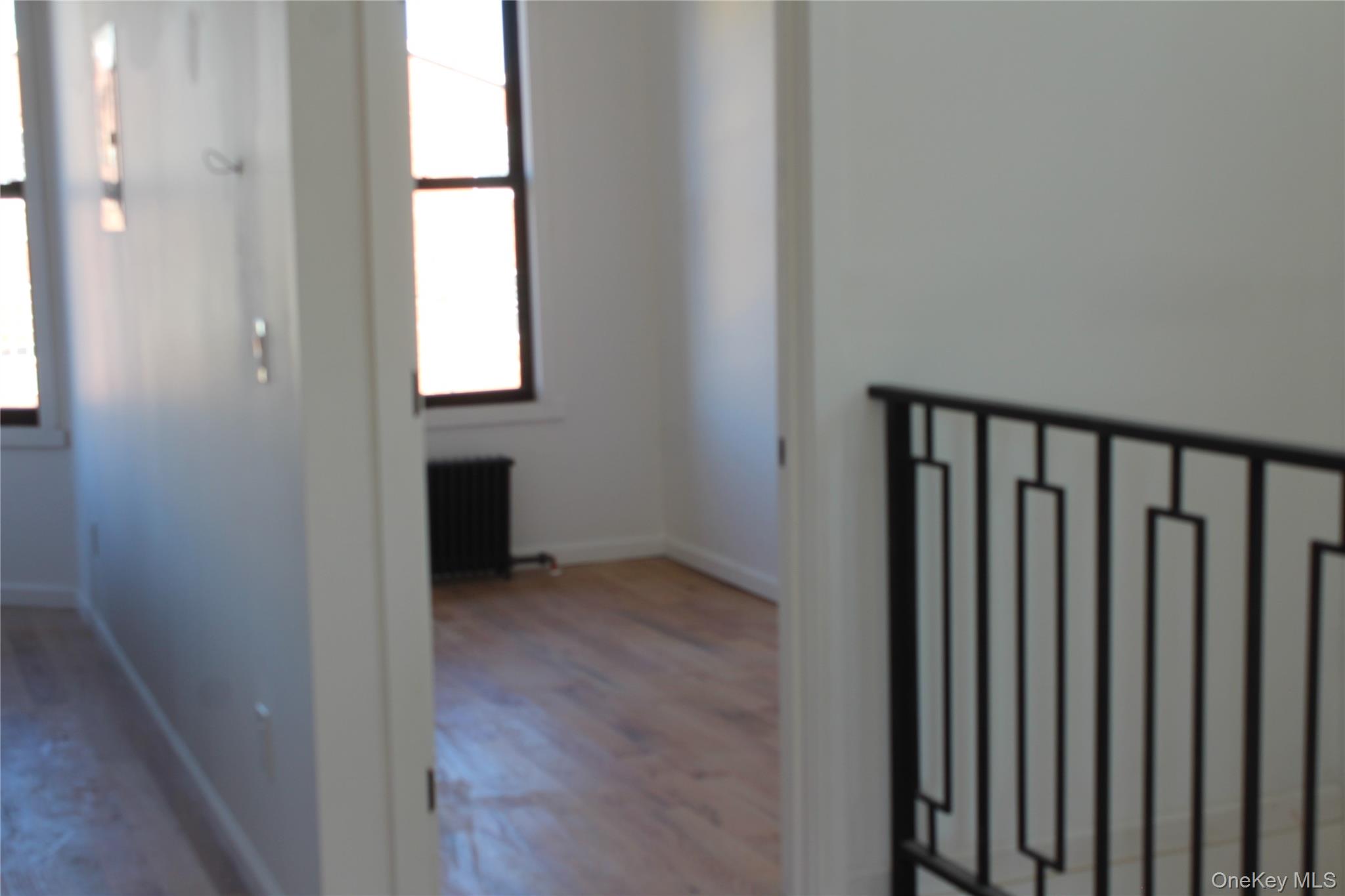 816 Barbey Street, Unit 2 Brooklyn, NY 11207 - Photo 8 of 11 a view of a hallway with wooden floor