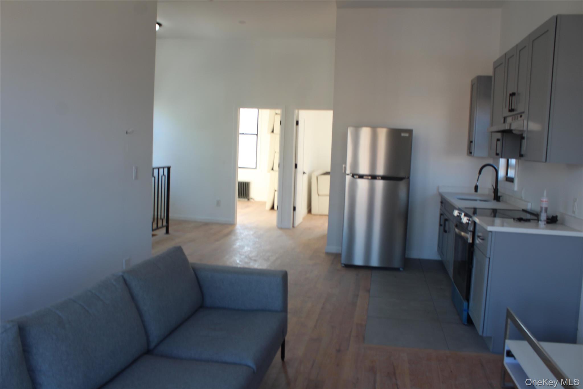 816 Barbey Street, Unit 2 Brooklyn, NY 11207 - Photo 9 of 11 a kitchen with refrigerator and window