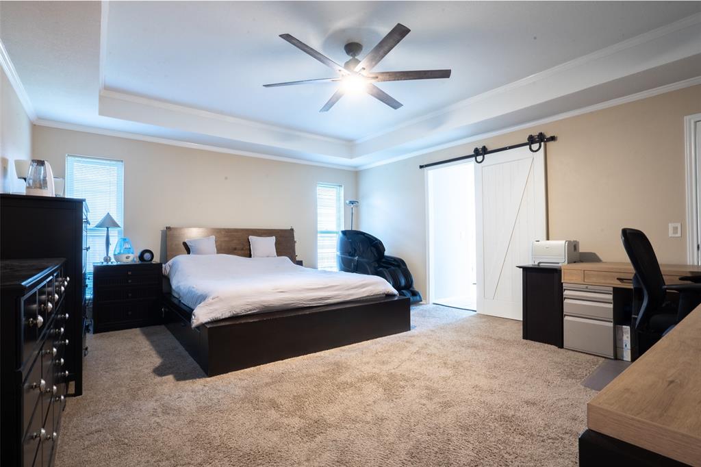 3905 Cross Bend Road Plano, TX 75023 - Photo 22 of 27 a bedroom with a bed and a flat screen tv