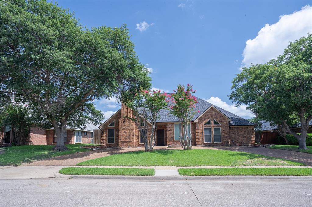 3905 Cross Bend Road Plano, TX 75023 - Photo 23 of 27 a front view of a house with a garden and trees