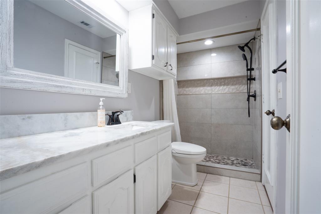 3905 Cross Bend Road Plano, TX 75023 - Photo 9 of 27 a bathroom with a granite countertop sink toilet and shower