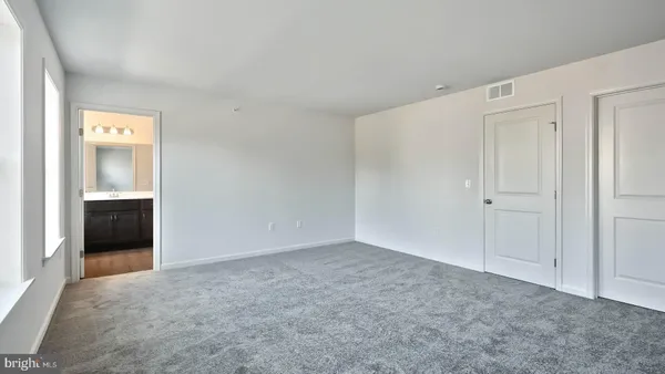 a view of an empty room and a window