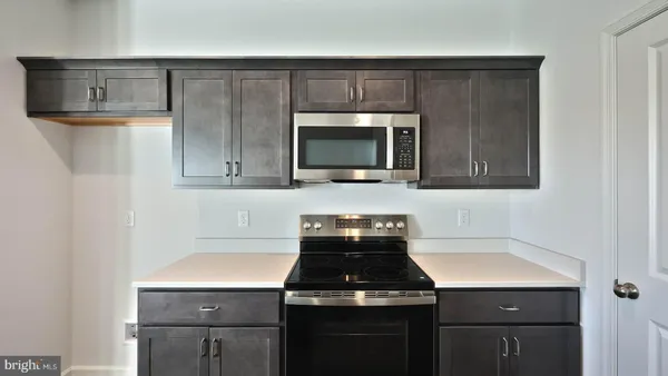 a kitchen with a stove and a microwave