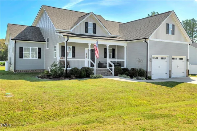a front view of house with yard and trees