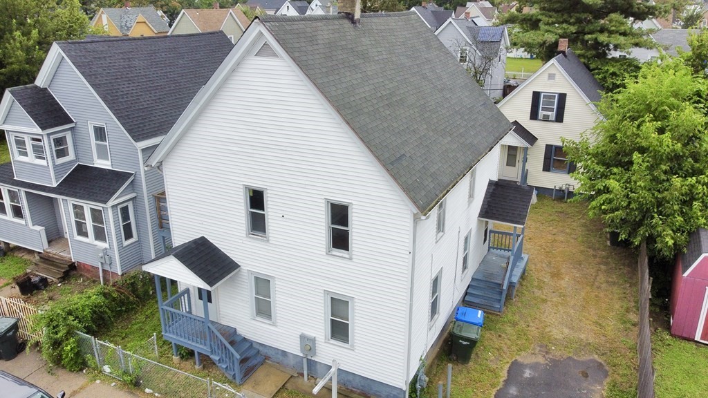 a view of a house with brick walls and flower plants