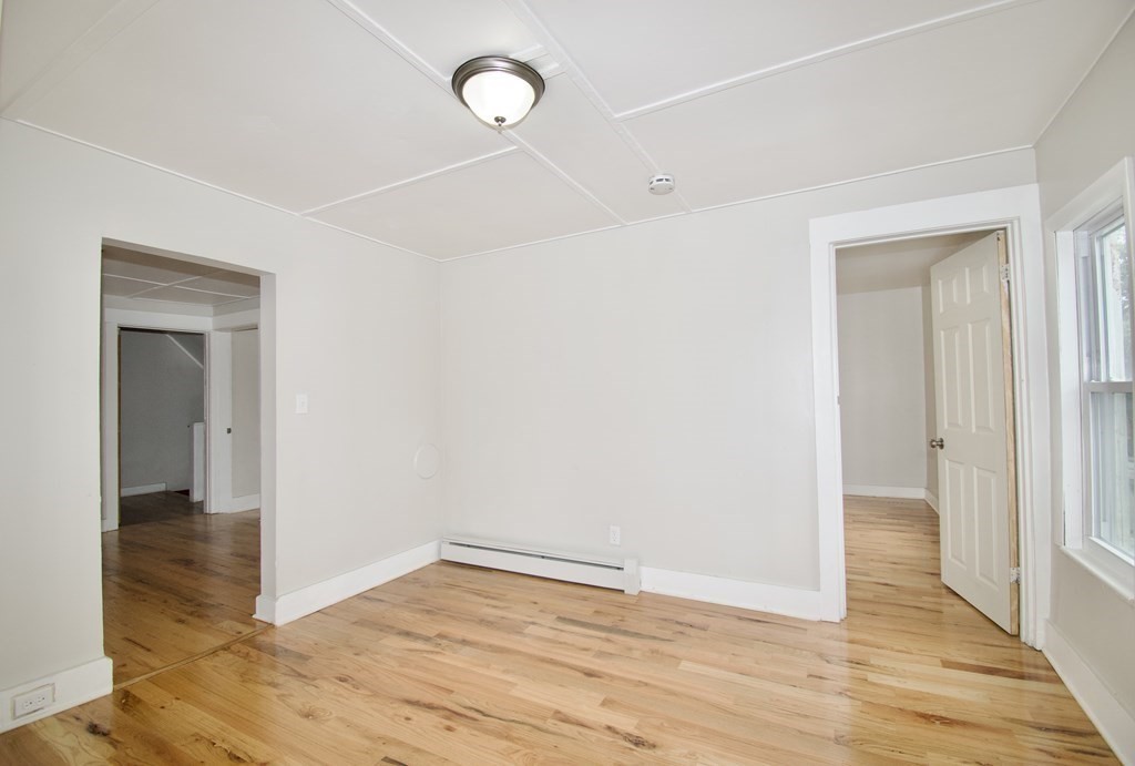38 Collins Street Springfield, MA 01109 - Photo 20 of 39 a view of an empty room with wooden floor and a window